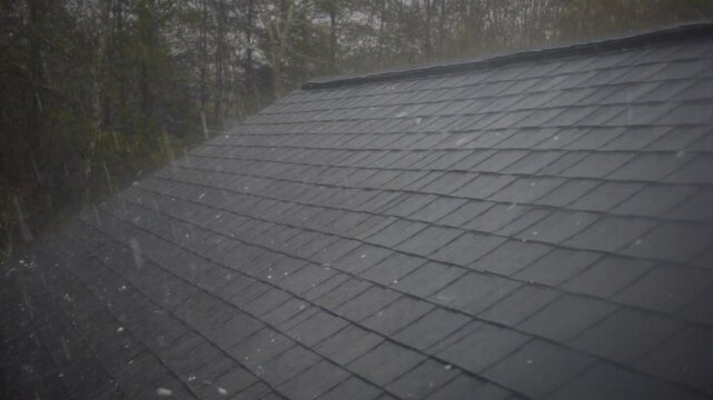 Hailstorm causing roof damage to house 