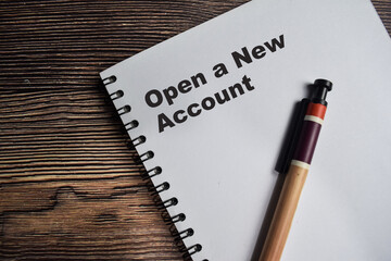 Concept of Open a new account on book isolated on Wooden Table.