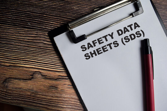 Concept of Safety Data Sheets - SDS write on paperwork isolated on Wooden Table.