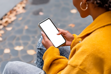 Hands of an unrecognizable woman using a cell phone with blank screen outdoors, African American woman texting, chatting, shopping, etc.