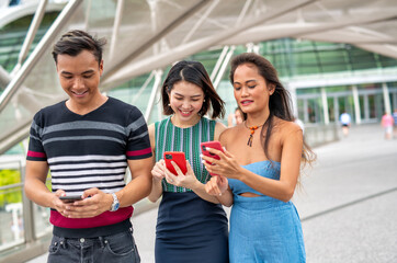 Three young asian friends spending outdoor time together in the city