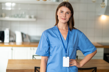 Cheerful female wearing light-colored uniform in hospital or clinic
