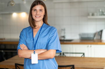 Woman in medical uniform standing in office providing administrative service