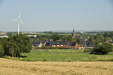 Le village de Ghislenghien dominé par une éolienne se dressant haut dans le ciel dans l'entité...