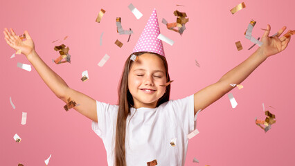 Happiness, entertainment and birthday. Excited child with closed eyes in festive hat enjoying...
