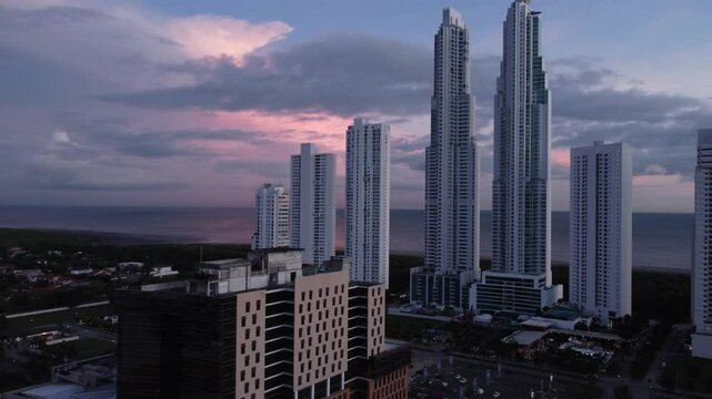 Aerial view from a drone in the Costa del Este neighborhood with the Panama City skyline over Panama City at sunset.