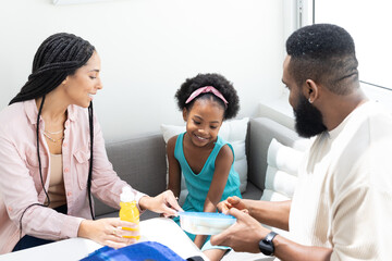 Fototapeta premium Family enjoying quality time together at home, sharing snacks and smiles