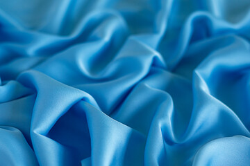Obraz premium Elegant folds of bright blue silky fabric with smooth texture and shine