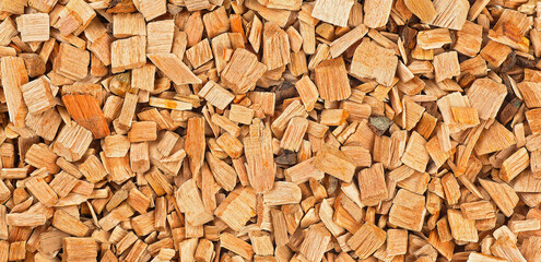 Background from wood shavings for smoking meat and fish. Wooden smoking chips, top view.