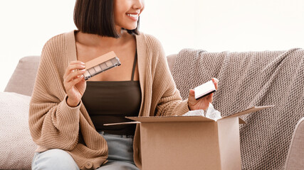Beauty Box Concept. Portrait of smiling asian lady received delivery package, holding eyeshadow...