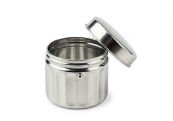 A metallic container with an open lid resting on the edge of the container