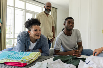 Friends gathering at home, smiling and enjoying time together before wedding event