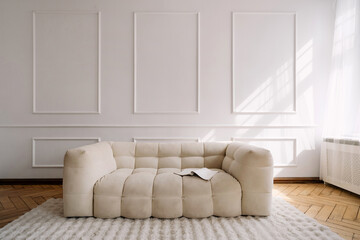 Modern white interior featuring a comfortable couch in a stylish apartment