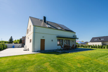 Obraz premium Rear of new build fully detached house with solar panels