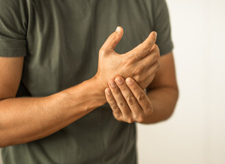 Man suffering from pain in hands and fingers, arthritis inflammation. Red highlight
