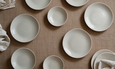Elegant Table Setting with Textured Off-White Plates and Linen Napkins