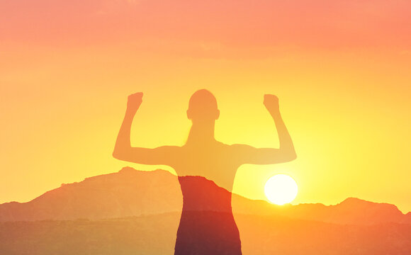 Strong woman, winning, success, determination, and life goals concept sunset background 