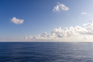 Expansive View of the Pacific Ocean Near Hawaii under Blue Sky with Clouds