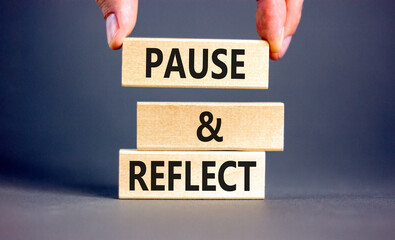 Pause and reflect symbol. Concept words Pause and reflect on beautiful block. Businessman's hand. Beautiful grey background. Business motivational lifestyle pause and reflect concept. Copy space.