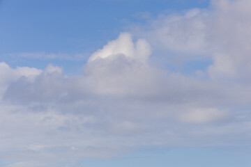 Bright Blue Sky with Fluffy White Clouds on a Sunny Day