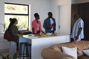Selbstklebende Fototapeten Family gathering in modern kitchen, friends chatting and preparing food together © wavebreak3