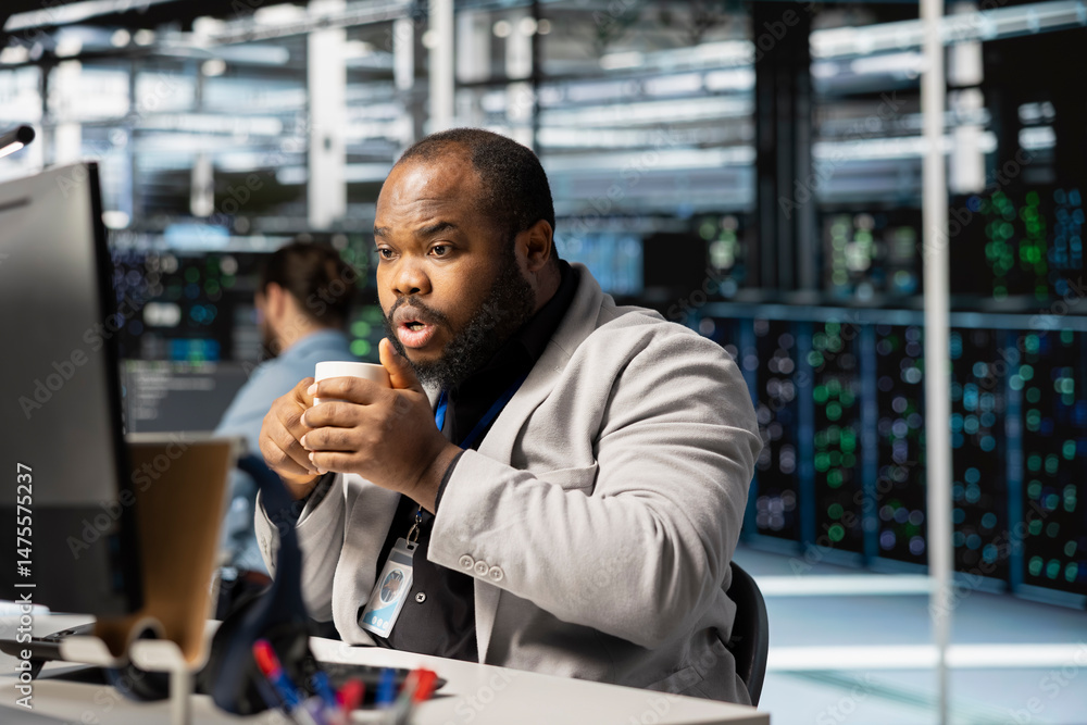 Poster data center technician drinking coffee analyzing software logs metrics on pc, optimizing storage sys