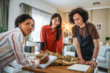 three females work together on new product at tailor studio