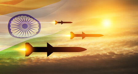 Fired missiles fly to the target. Missiles at the sky at sunset with Indian flag. Missile defense,...