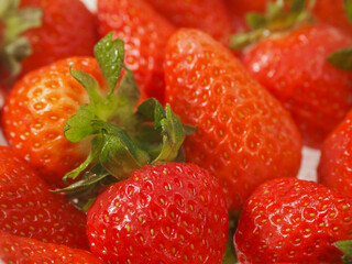 Close up of pile of strawberry. Fine fruits. White background. Tasty snack. Agriculture industry and food supply.