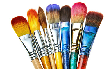 Fototapeta premium Collection of art supplies including paintbrushes and watercolor paints arranged creatively for artistic use