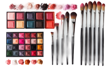 Assortment of painting tools featuring watercolor palettes and various sizes of paintbrushes on workspace