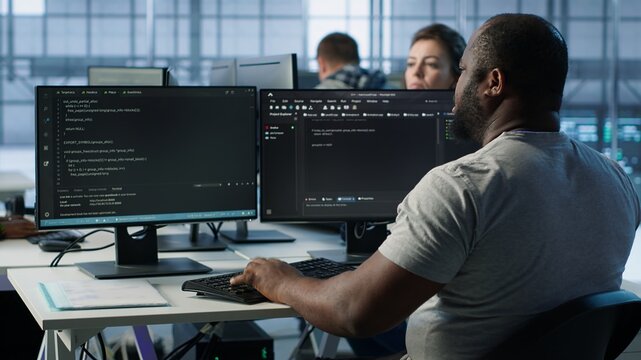 Admin programming in server room housing advanced equipment storing massive datasets. Developer typing code on PC to mend data center racks doing complex computational operations, camera A - Powered by Adobe