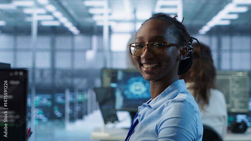 Poster portrait of smiling woman tasked with doing checkup on server room rows providing computing resource