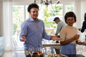 African American couple enjoying drinks and conversation at elegant indoor gathering