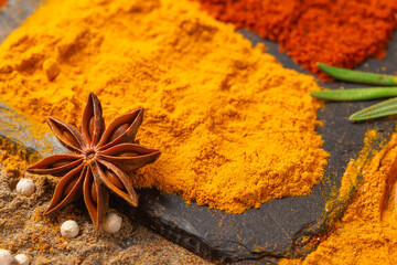 star anise close-up and spices turmeric, paprika, cardamom, nutmeg, and allspice.