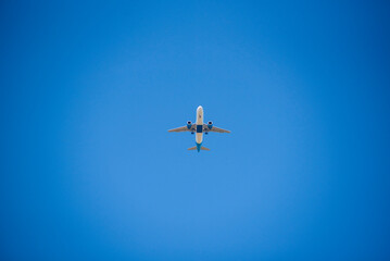 Big white passenger plane in blue sky