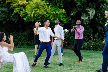 Guests joyfully dancing and celebrating together at outdoor wedding reception