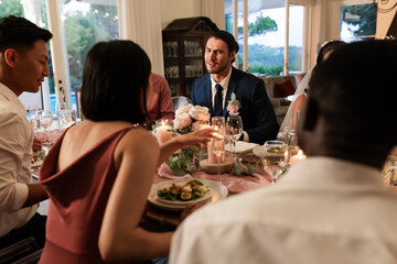 Guests enjoying dinner and conversation at elegant wedding reception table