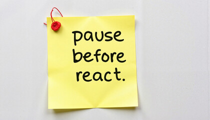 Sticky note with motivational phrase 'pause before react' on a white background