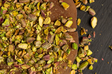 pistachios for cooking , chopped into pieces crispy pistachios fried with salt, side view
