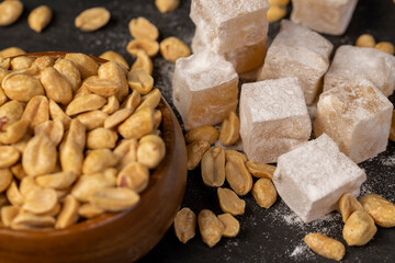 square Turkish delight in powdered sugar with nuts inside, scattered oriental sweets Turkish delight with peanuts
