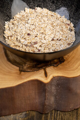 bowl of oatmeal porridge with dried berries and fruits, filled with instant oatmeal porridge with additives, closeup