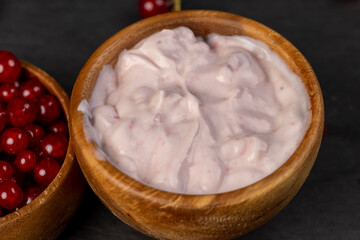 yogurt and currants, a red fermented milk product made from milk with the addition of red sweet and sour currants and currant flavor