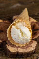 cup with vanilla ice cream on a board, cold and sweet vanilla ice cream made from cream with sugar