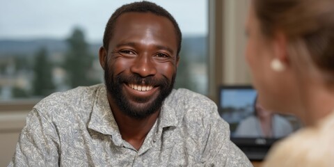 Smiling african adult male in conversation with caucasian female