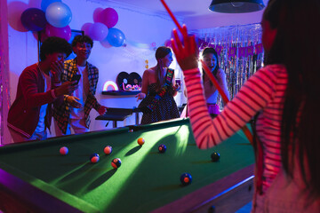 Playing pool and dancing, teenagers celebrating vibrant birthday party with friends