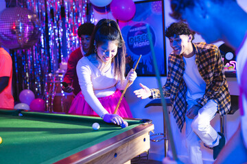 Teenagers playing pool at party, enjoying vibrant celebration with friends