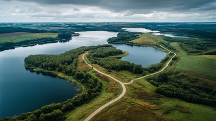 Obraz premium Serene Scenery Lake and Road Encircled by Greenery