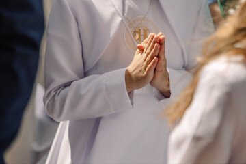 Child Praying with Folded Hands During First Holy Communion Ceremony