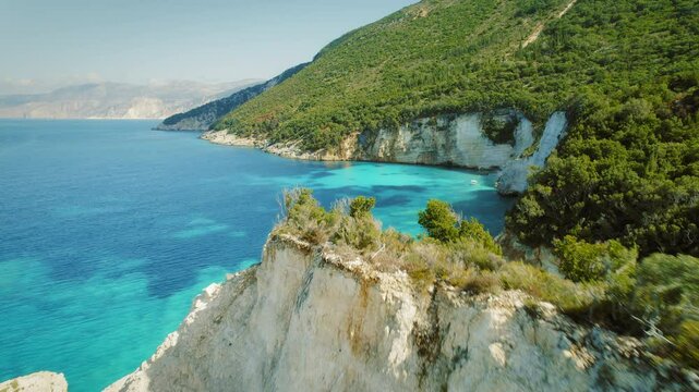 Couple enjoying the stunning cliffs and turquoise waters of summer Greece